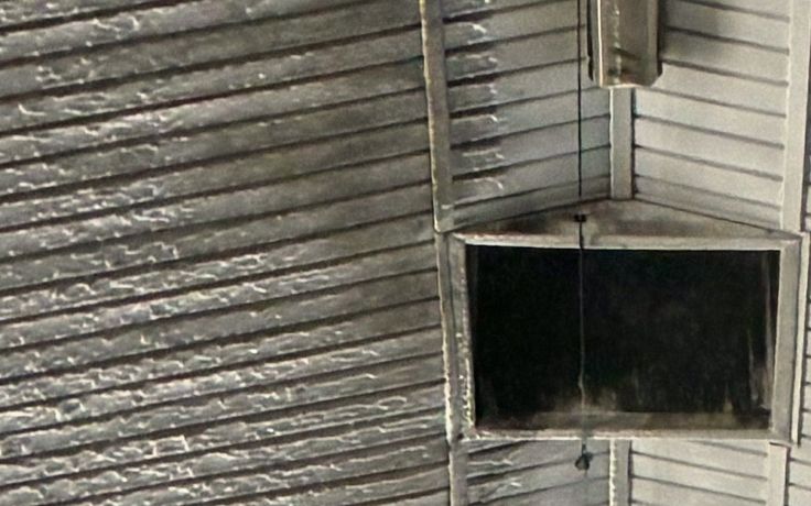Before: grey ribbed ceiling liner beside the ridge vent, streaked with dust and residue