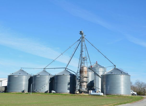 Grain bins and an elevator leg at a farm