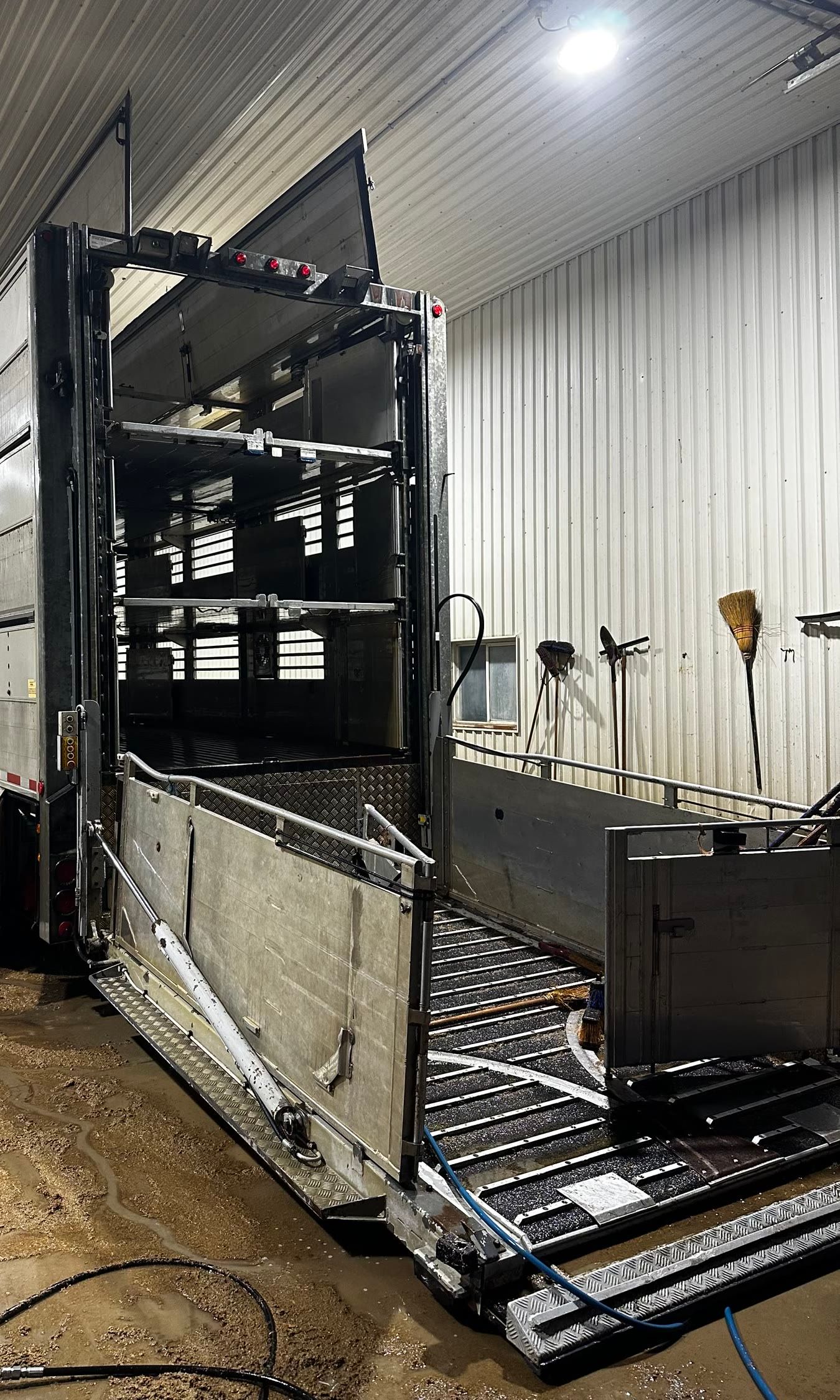 After: the same trailer from the other side of the bay, washed, with its decks and ramp clean down to the metal.