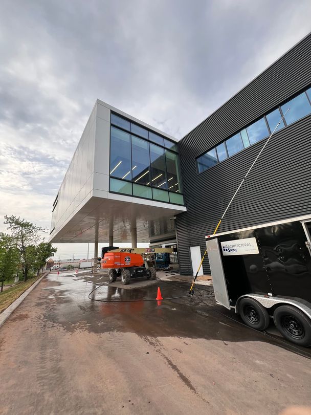 Architectural Shine trailer and telescoping pole on site at a new car dealership during a post-construction wash